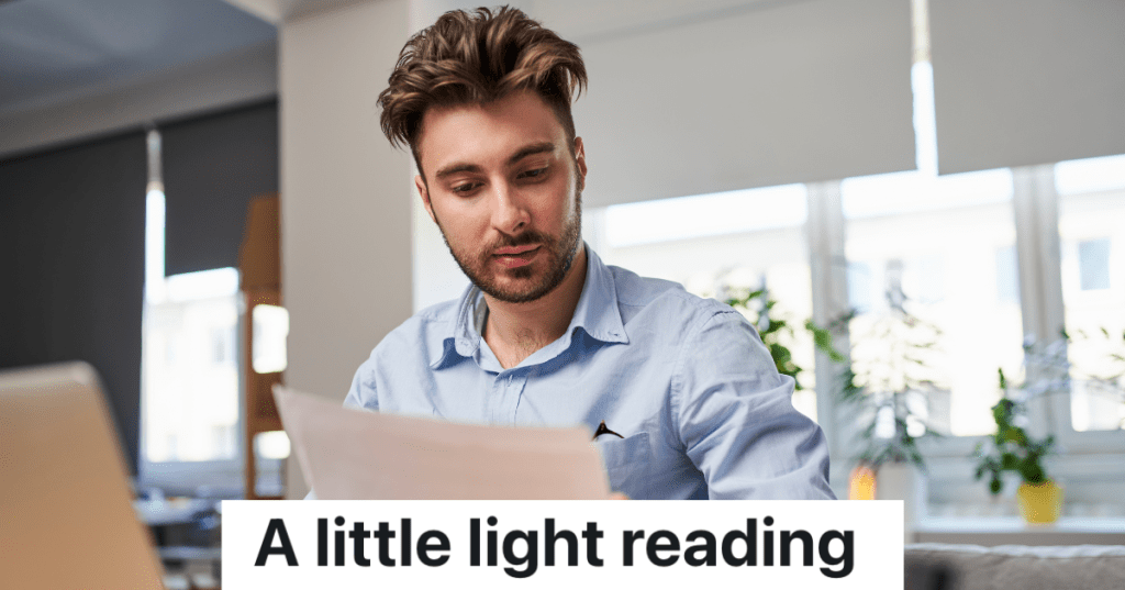 man reading paperwork in his kitchen