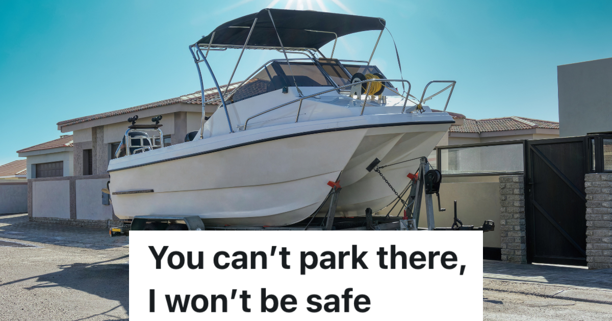 white boat parked on the street in front of a house