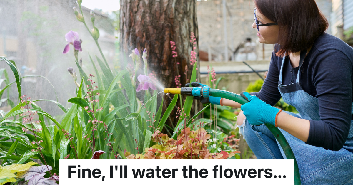 woman watering flowers with a hose