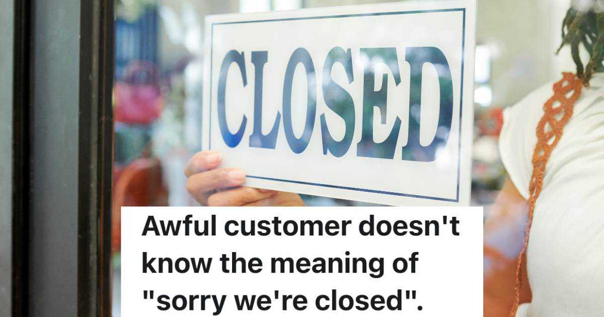 woman putting a closed sign in a store window