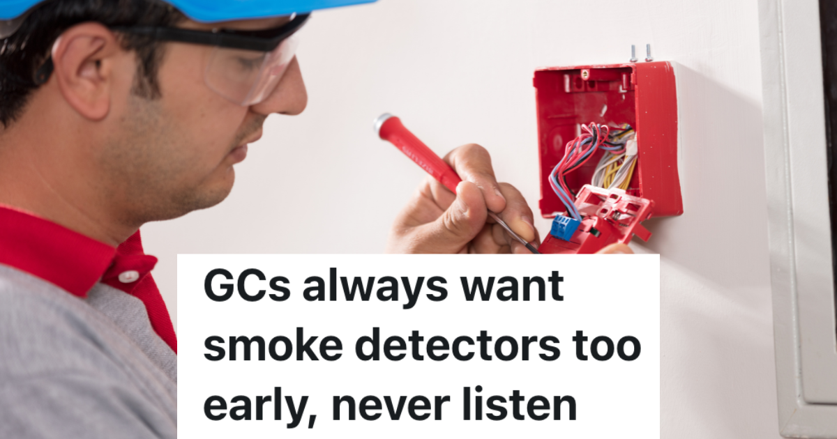 man installing fire alarm