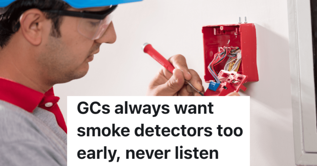 man installing fire alarm