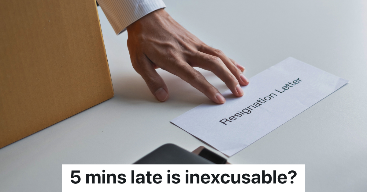 man's hand pushing resignation letter across desk