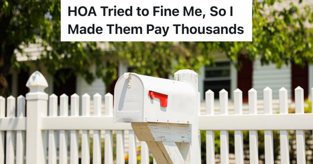 white mailbox in front of a house with a white picket fence