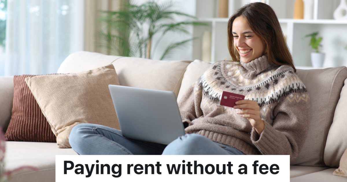 smiling woman sitting on couch with laptop and credit card