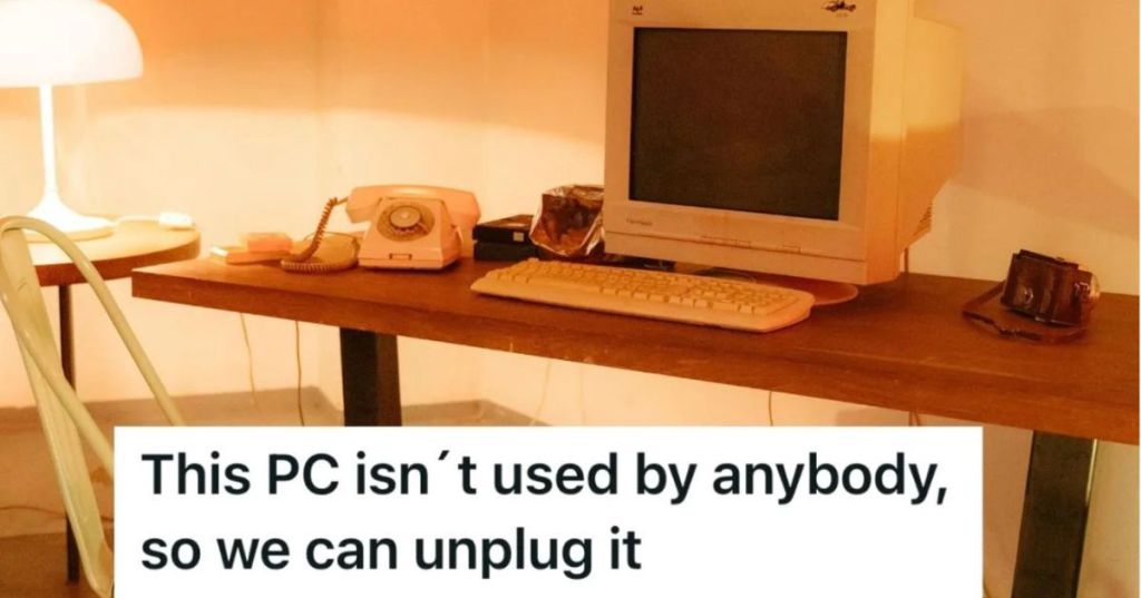 Old computer on a desk in a dimly lit room