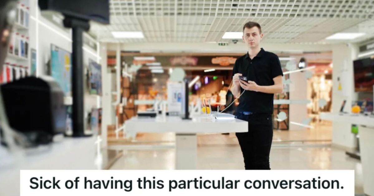 electronics store employee standing in the middle of the store