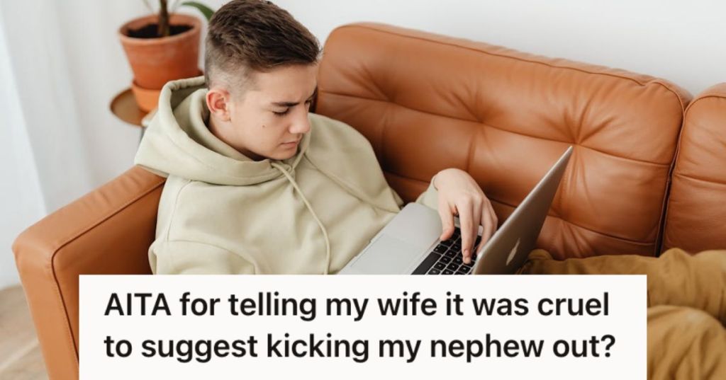 Teenager boy using his laptop while sitting on a couch