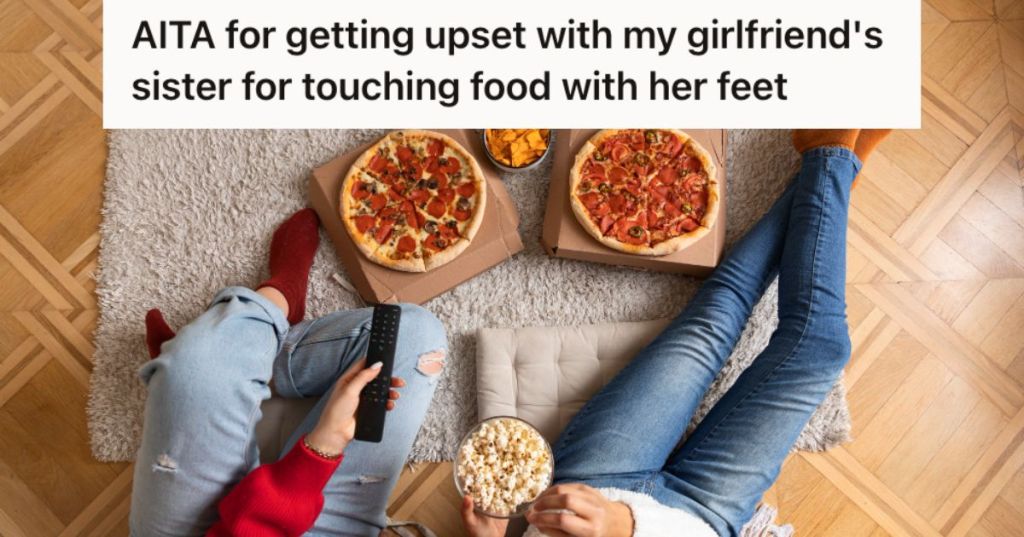 Two people eating pizza and popcorn on the floor