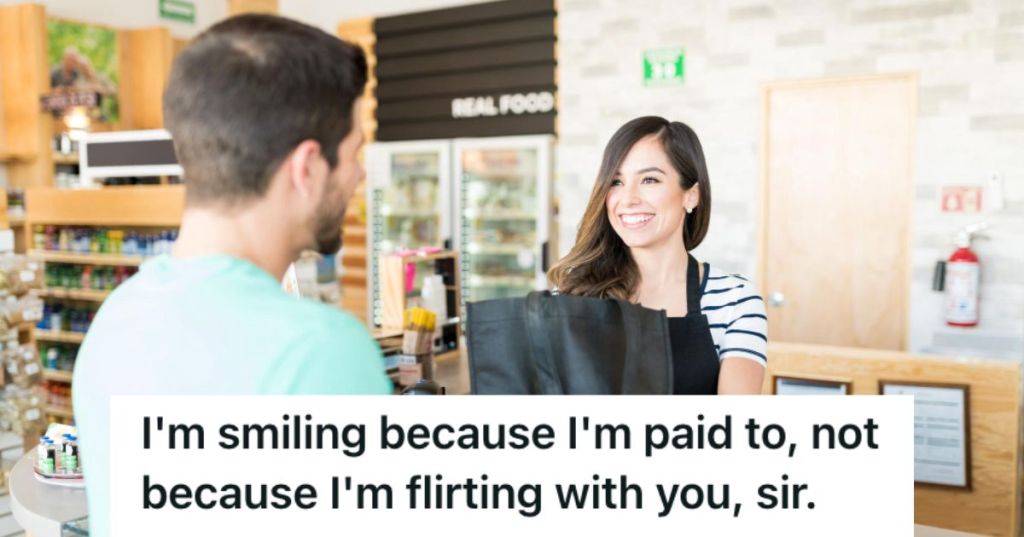 Cashier smiling at the customer while handing his grocery bag