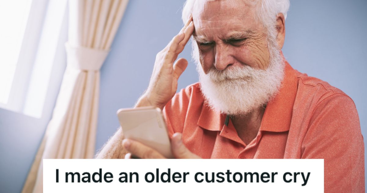 Old man with beard feeling sad while looking at his phone