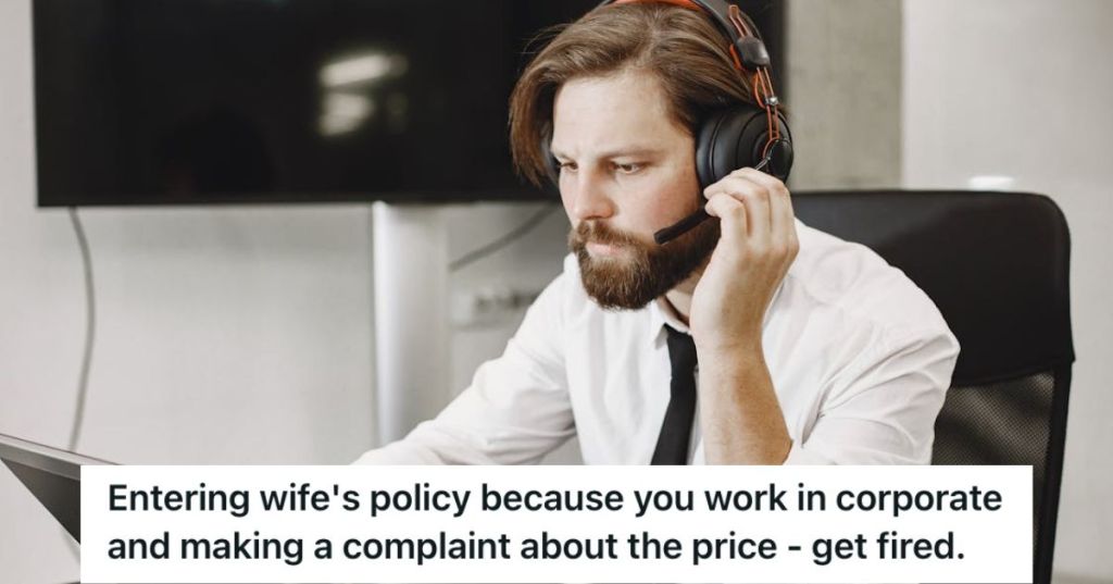 Call center employee wearing a hedset and looking at his laptop