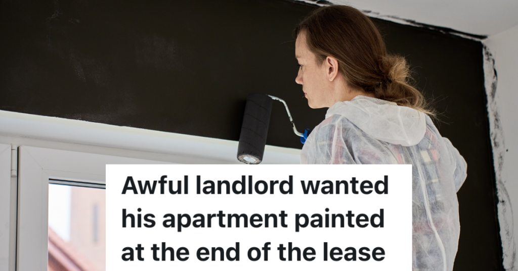 woman painting a wall black