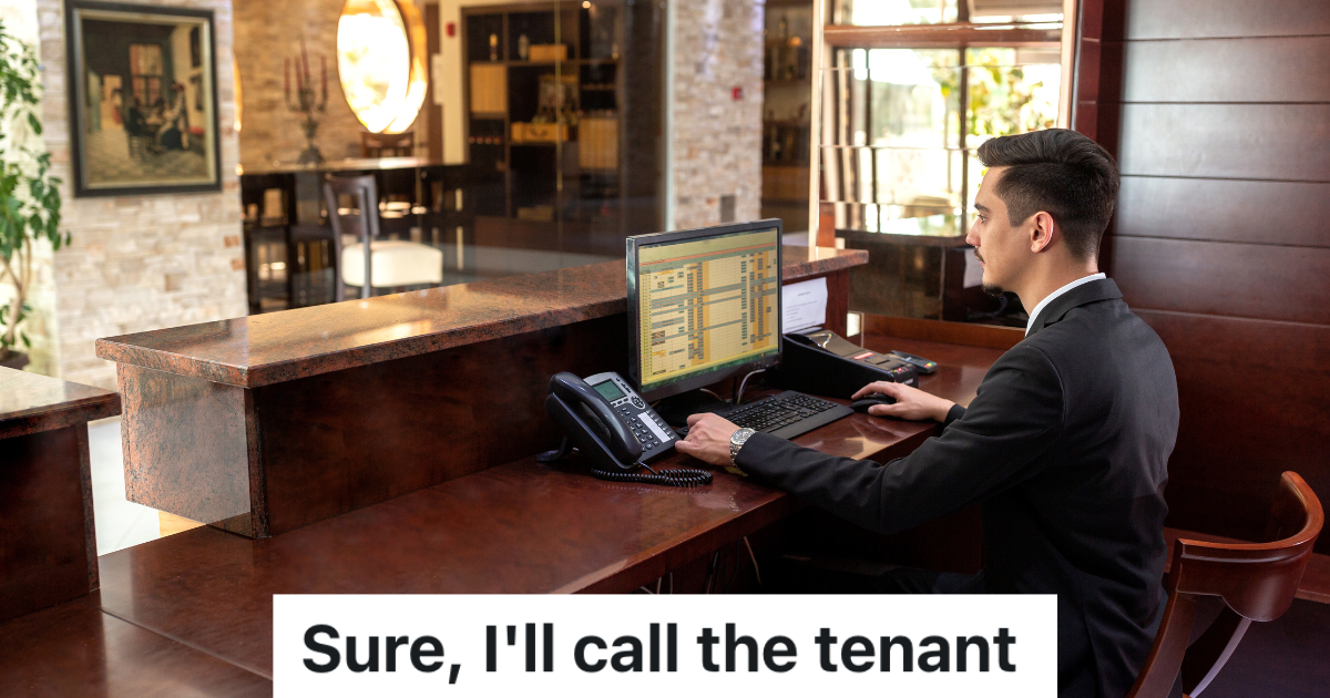 male receptionist in a suit looking at a computer