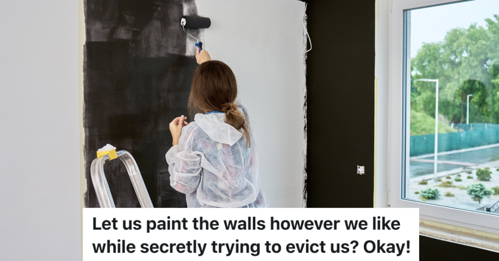 woman painting a room black