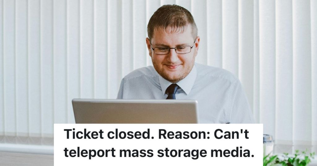 Man in office, typing on a laptop and smiling