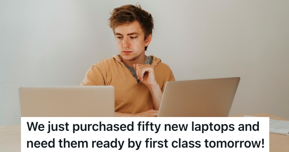 A man working on two laptops