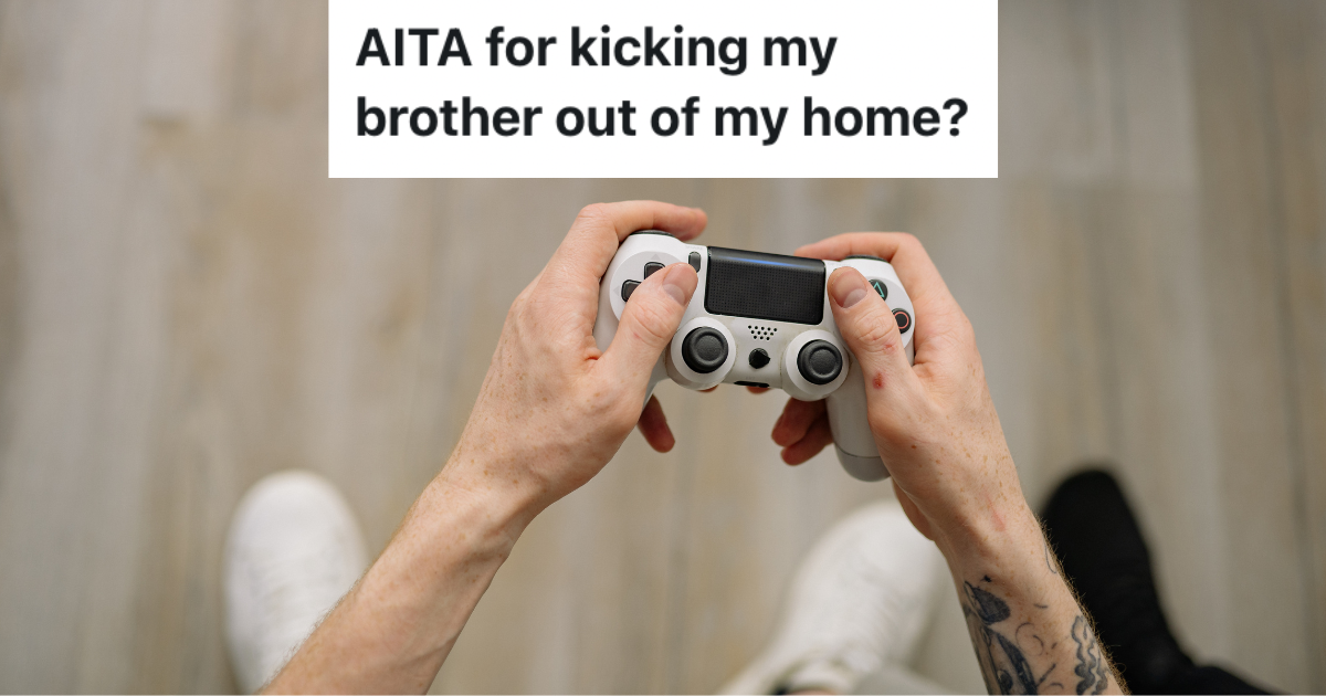 Overhead of hands holding game controller.