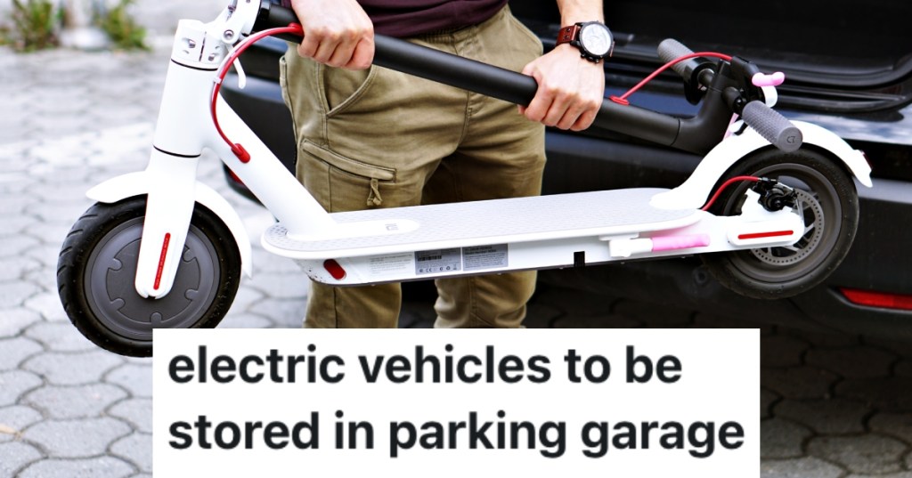 man holding a scooter