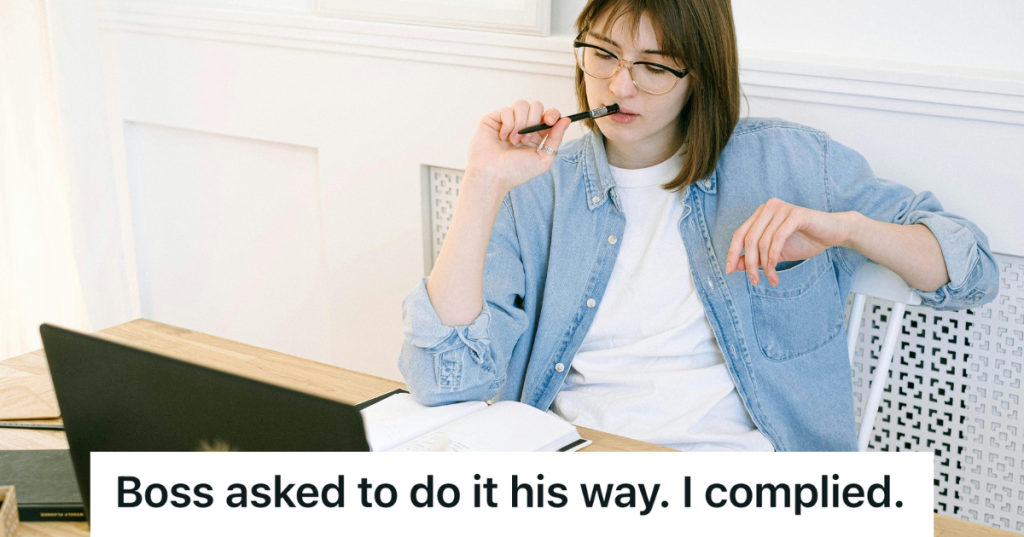 freelancer writer with pen in mouth sitting at desk