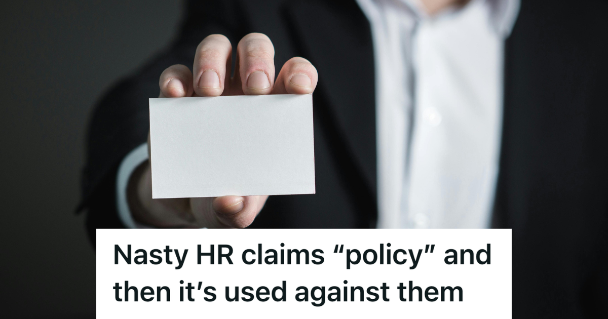 man holding up a blank business card