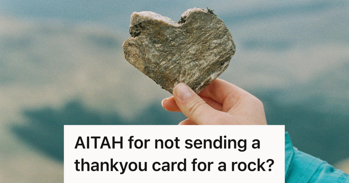 man holding up a rock