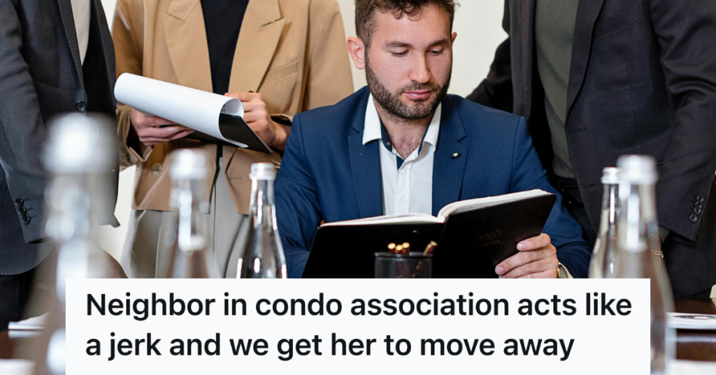 man in a suit reading a black book