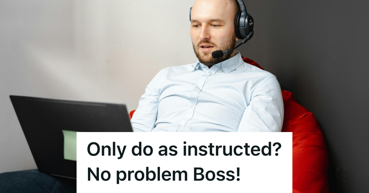 man working at laptop with headphones on