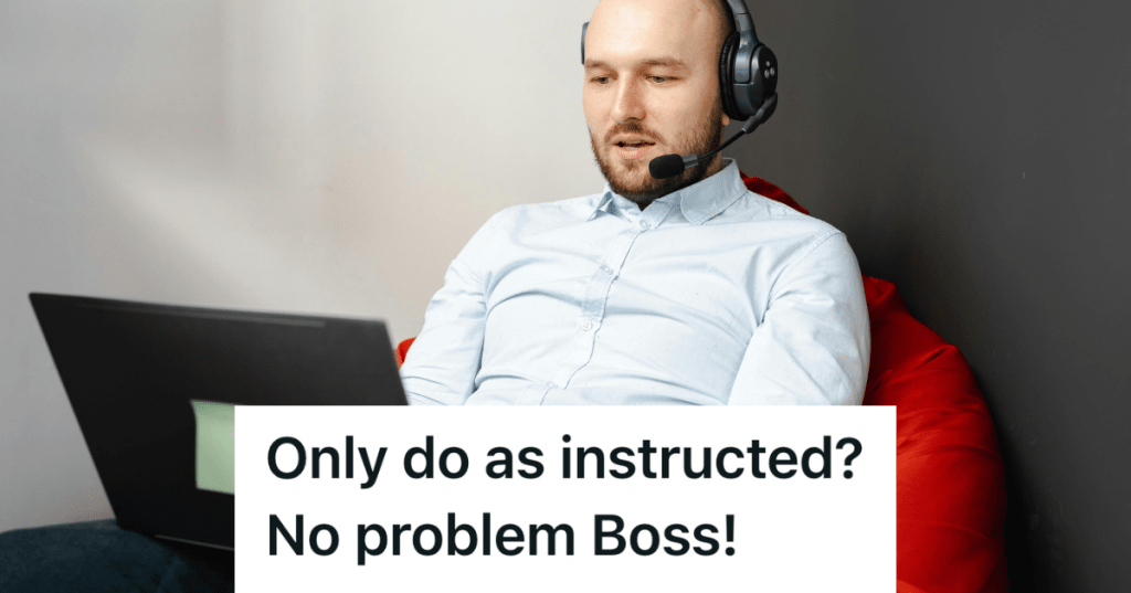 man working at laptop with headphones on