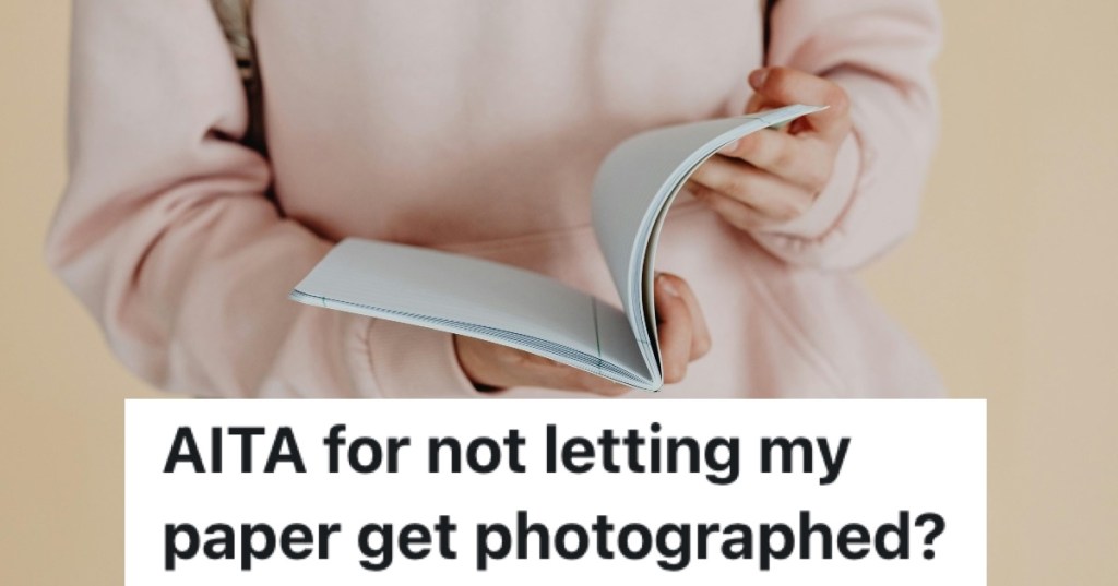 woman in pink leafing through a book