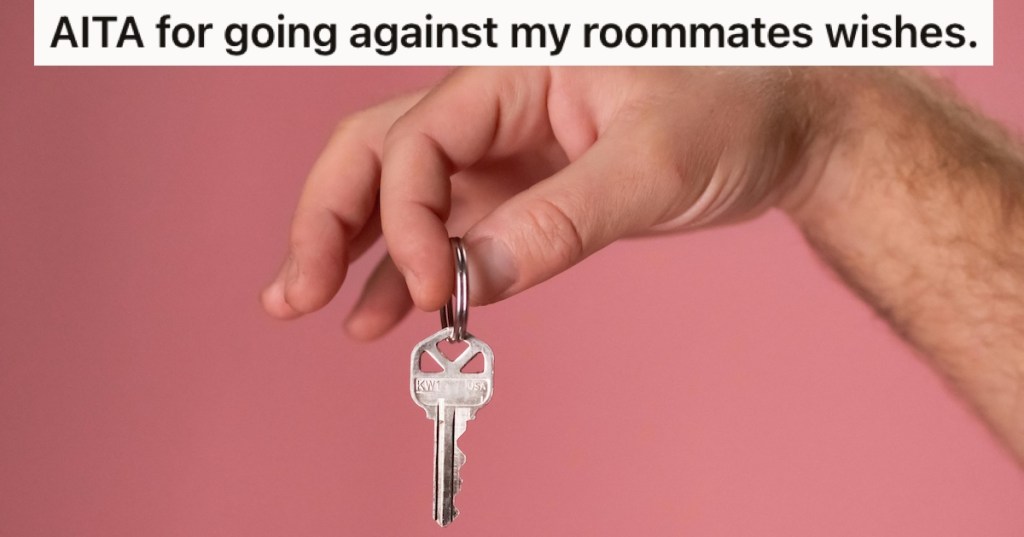 A man's hand holding a key