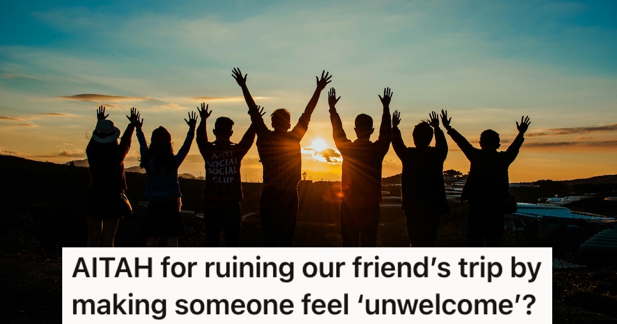 A group of people raising their arms in the air at sunset