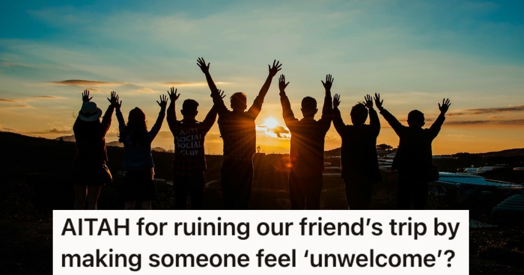 A group of people raising their arms in the air at sunset