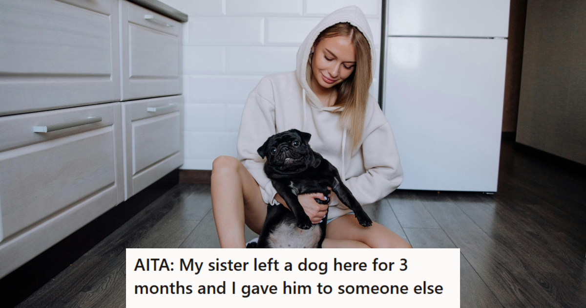 Woman in hoodie holding a black dog