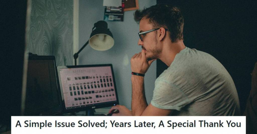 Man in grey shirt working on his computer