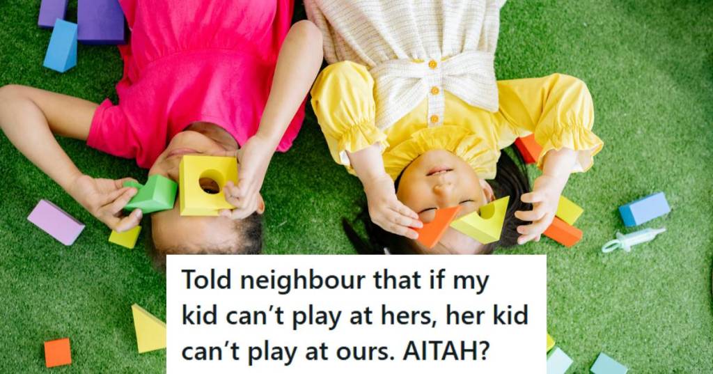 Two little girls playing on the ground with blocks.