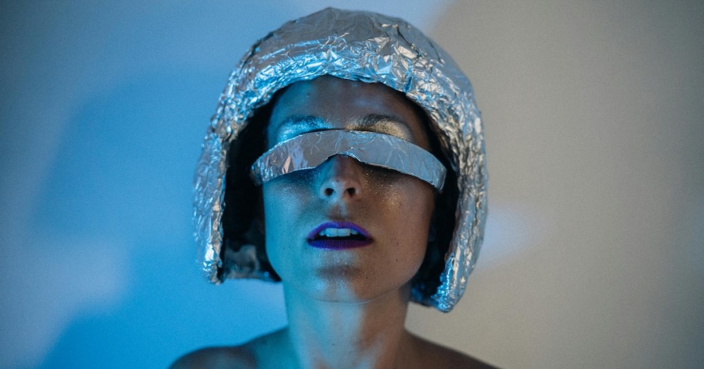 A woman wearing a tinfoil hat
