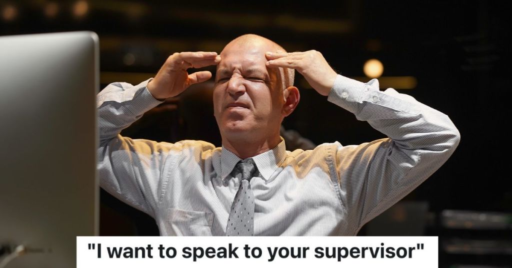 stressed out hotel manager looking at computer