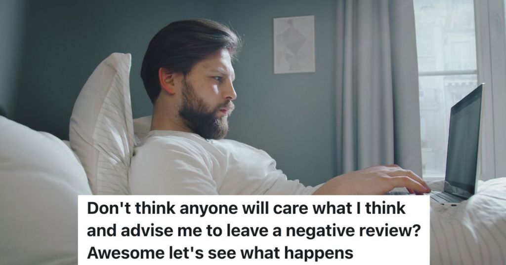 man in bed typing on laptop