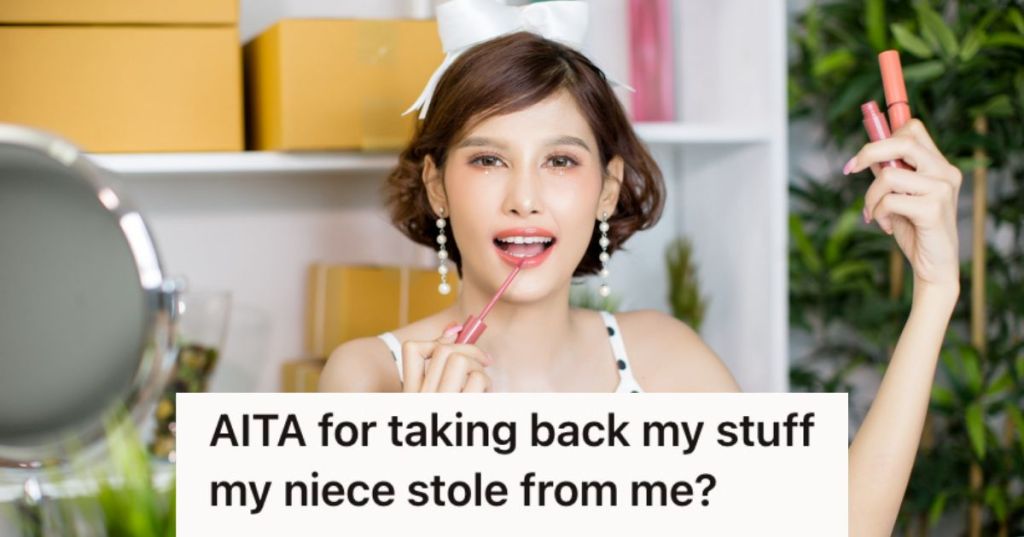 Young teen putting on lipstick