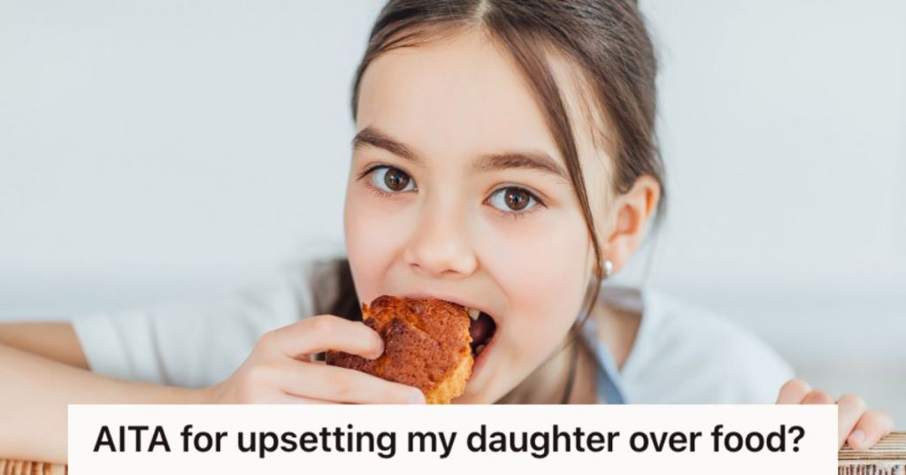 Young girl taking a bite of a cupcake