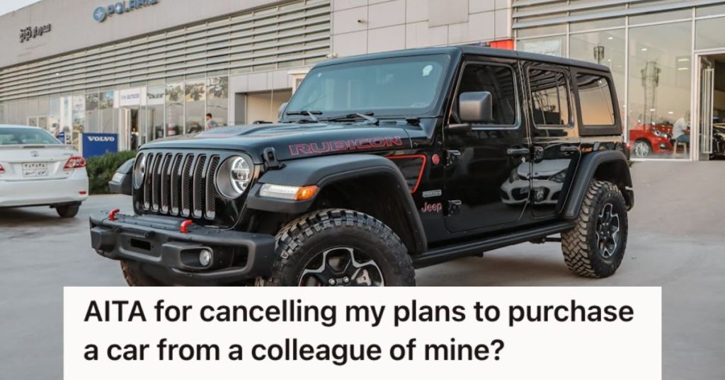 A black Jeep in front of a showroom