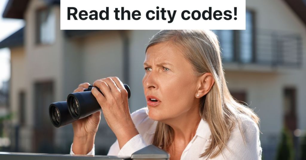 older woman looking over fence with binoculars