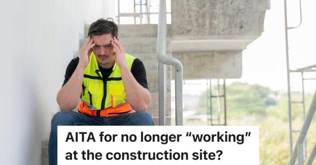 upset construction worker sitting on steps