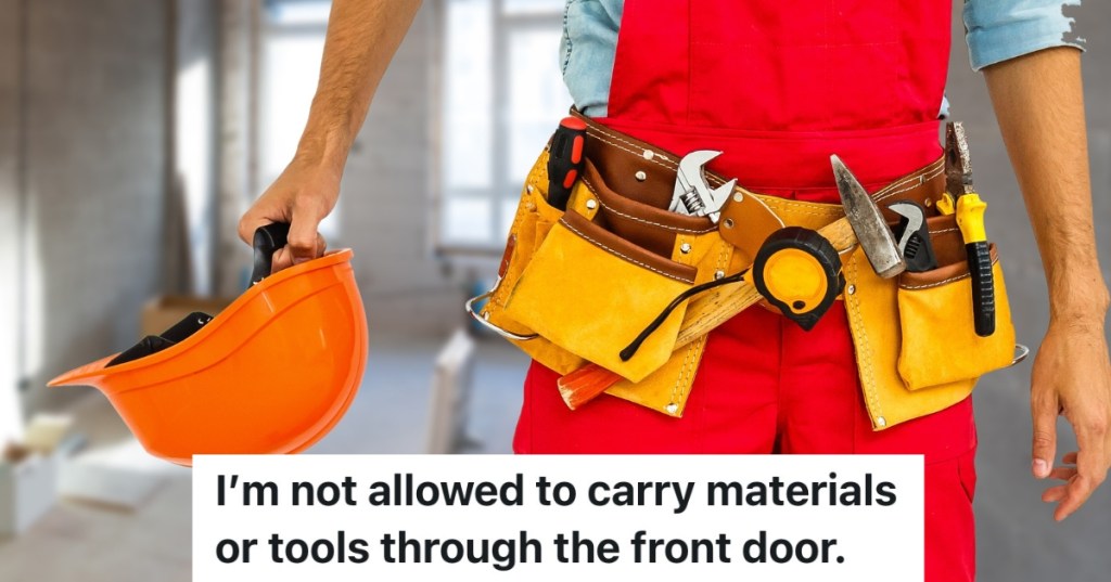 man wearing a tool belt and holding a hardhat