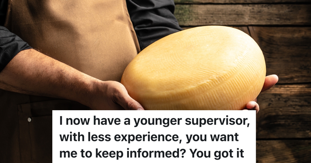 man holding a wheel of cheese