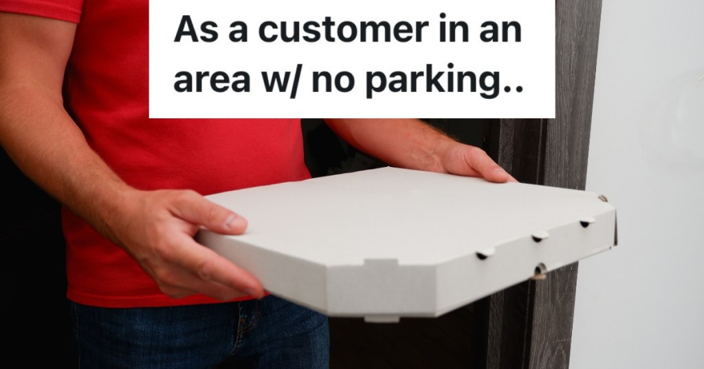 man in red shirt holding a pizza box