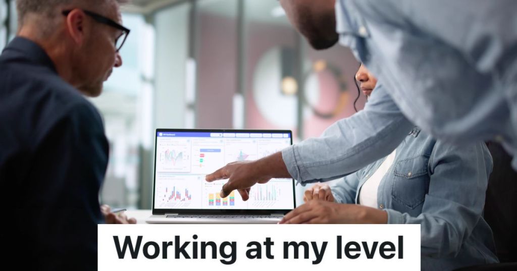 businessman pointing at a computer screen with charts on it