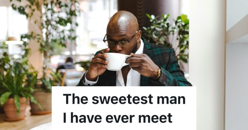 Man sipping from coffee cup in coffee shop