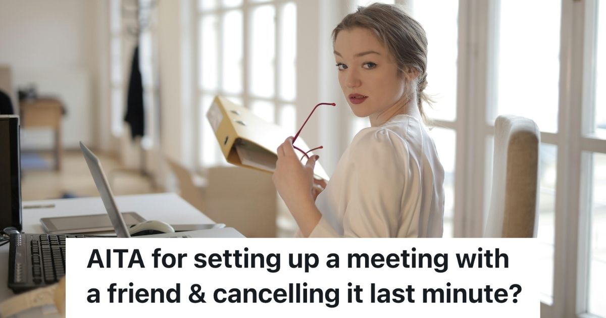 Woman posing with glasses and a binder at a desk
